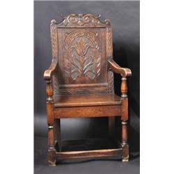 An oak Wainscot chair, the acanthus carved scrolling top rail above a floral carved panel back, dow.