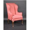 Image 1 : An 18th century wing back armchair, the padded back and wings above scrolling padded arms and a cus.