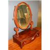 Image 1 : A George III mahogany serpentine dressing mirror, the oval plate supported on scrolling uprights ab.