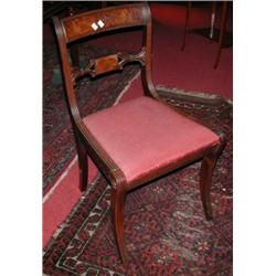 Three Regency mahogany dining chairs, each with reeded top rail above a scrolling tablet centred ra.