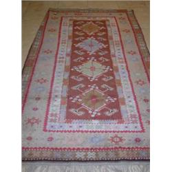 A Caucasian wool rug, the tan field enclosing four Herati motifs within geometric guard stripes and.