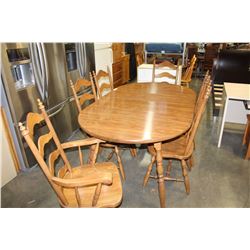 OAK FINISH TABLE WITH TWO LEAFS AND FIVE LADDER BACK CHAIRS