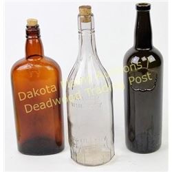 Group of 3 antique liquor bottles showing good condition.  Est. 25-75