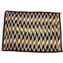 Good Navajo rug in tan, white and brown's, diamond pattern showing good overall condition, 36" X 51"
