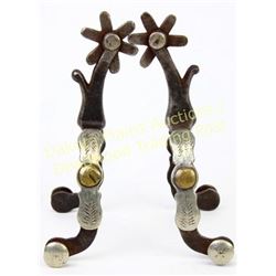 Unmarked McChesney single mounted spurs showing good overall condition.  Est. 250-450