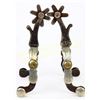 Image 1 : Unmarked McChesney single mounted spurs showing good overall condition.  Est. 250-450