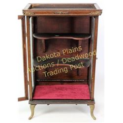 Small antique display cabinet counter top size, hinging front glass door, cast iron cabriole legs.  