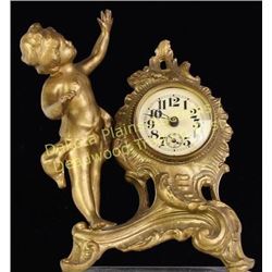 Victorian cupid clock in cast metal 7" tall in working order, very good condition, shows NO repairs.