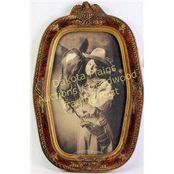 Wonderful reprint of a cowgirl and horse packing a Colt Bisley in double loop holster in vintage Ame