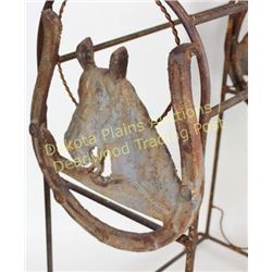 Ornimental iron saddle stand with cutour iron horse head plaques on each end, 37" tall.  Est. 100-20