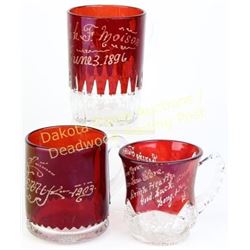 Collection of 3 early ruby stained souvenir cups with handles, etched with two dated 1896 and 1903, 