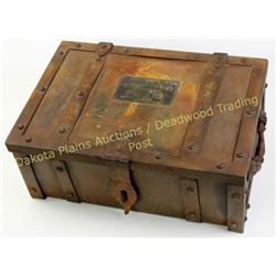 Reproduction iron strong box with brass Wells Fargo tag on lid, measuring 8 X13 X19 , an older copy 