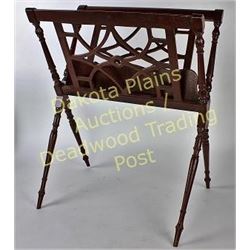 Mahogany floor model magazine rack on turned legs 25" tall.  Est. 25-50