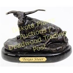 Contemporary "Texas Steer" bronze by Charlie Russell on black marble base, 6" long.  Est. 50-100