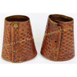 Pair basket stamped cowwboy cuffs 5.5" long, one missing snaps.  Est. 25-50