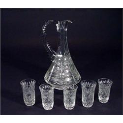 Heavily cut glass ewer and five glasses, 3…