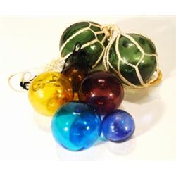 Seven assorted glass witches balls in gree…