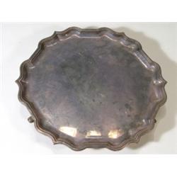 Circular scrolled silver tray on hoofed fe…