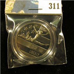 1992 S Olympics Gymnastics Proof 68+ Commemorative Half-Dollar, encapsulated.