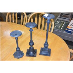 THREE METAL CANDLESTICKS