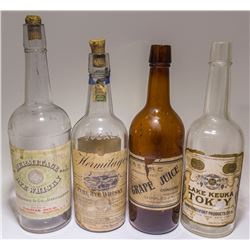 Four Full Face Labeled Whiskey Bottles