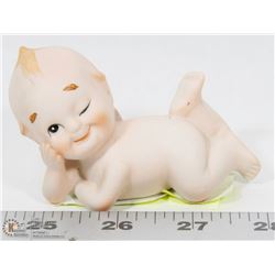 ANTIQUE WINKING BABY STATUE.