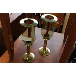 TWO BRASS AND GLASS CANDLE HOLDERS