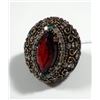 Image 1 : Silver and brass ring set with central red gemstone