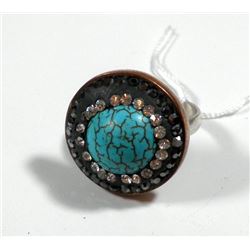 Silver and brass ring set with central turquoise gemstone