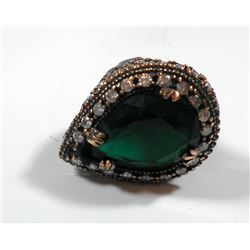 Silver and brass ring with large green gemstone setting in the center