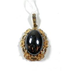 Oval K8 gold pendant with hematite setting
