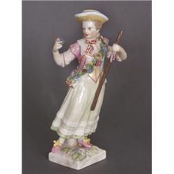 Porzellanfigur. Gärtnerin. Auf quadratischem Sockel stehende, blumengeschmückte Figur. Polychrome...