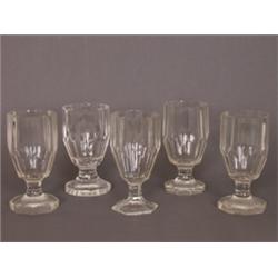 Fünf Pokale. Farbloses Glas. Achtfach facettierte Wandung auf oktogonalem Stand. 19. Jh. H: 14,5...