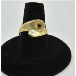 18RPS-31 DIAMOND RINGOne modern yellow gold bypass ring set with  an accent diamond and a topaz EST: