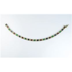 18CAI-39 BRACELETGorgeous bracelet featuring forty six  baguette cut Rubies, Sapphires and Emeralds 