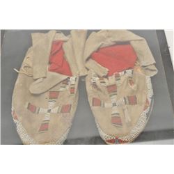 18AP-69 BEADED MOCSPair of Indian beaded moccasins in riker  case; cross designs.      Est.:  $100-$