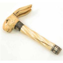 A Victorian ivory stick handle in the form of a rabbit, with silver mounts and glass eyes, 5.5ins...