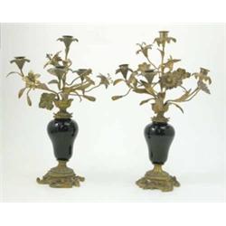 A pair of late 19th century Continental gilt metal candelabrum, each with four flower head branch...