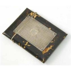 A late 19th century tortoiseshell card case, with inset foliate engraved silver panel, 4 ins...