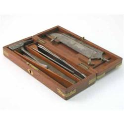 A surgeons field set in brass bound mahogany case, the hinged lid enclosing a compartmented inter...