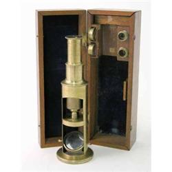 A J.H Steward miniature brass monocular microscope, in mahogany case, 7 ins...