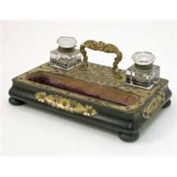 A late 19th century ebonised and brass mounted walnut desk stand, with pen recess and two chamfer...