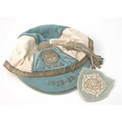 A blue and white velvet sports cap dated 1928-29, decorated with a rose and the initials Y.H.A an...