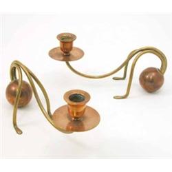 A pair of Carl Deffner Arts and Crafts copper and brass candle stands, the scrolling sconce arm s...