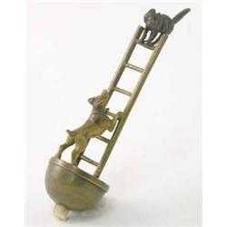 A novelty cold painted bronze bell switch, modelled as a dog and cat on a ladder, 4 ins...