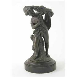 A late 19th century French bronze figure of a semi draped girl, modelled leaning against a tree s...