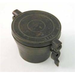 A set of bronze cup weights, the master cup with cover and clasp housing eight graduating weights...