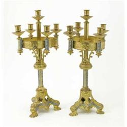 A pair of Gothic style gilt metal five branch table candelabrum, the knopped stem supported on tr...