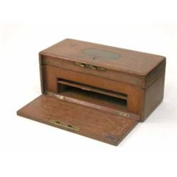 A mid 19th century tooled leather jewellery case, the hinged lid and fall front, with recessed br...