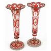 Image 1 : A pair of tall Bohemian ruby flash trumpet vases, with facetted stems, petal shaped rims and scro...